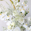 Close up of artificial floral arrangements with white orchid and roses